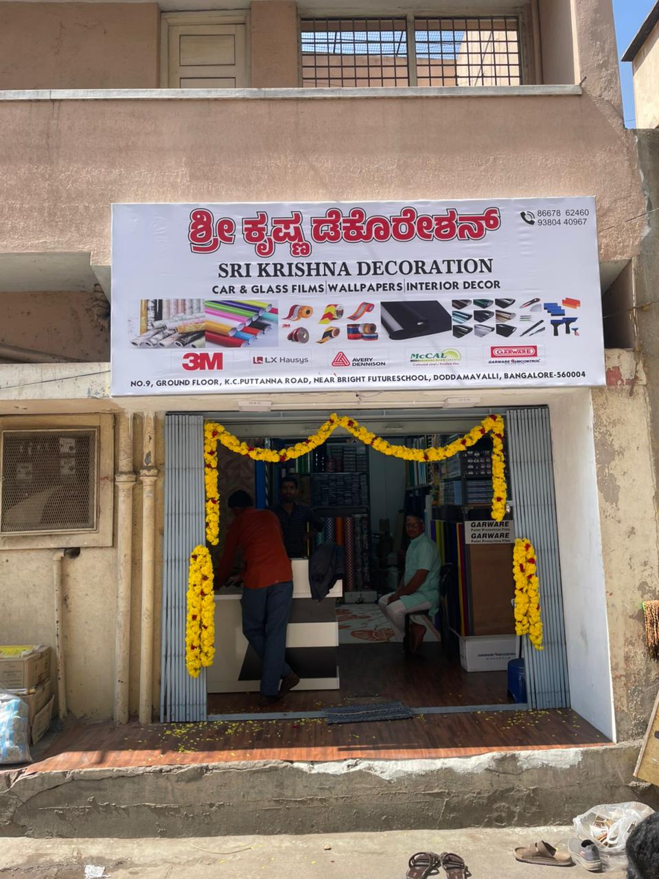 Sri Krishna Decoration storefront in Bengaluru, decorated with marigold garlands